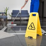 Janitorial cleaner mopping the floor